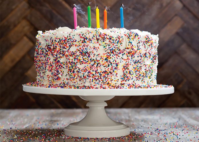 Chef Sarah Simmons Birthday Cake on white pedestal