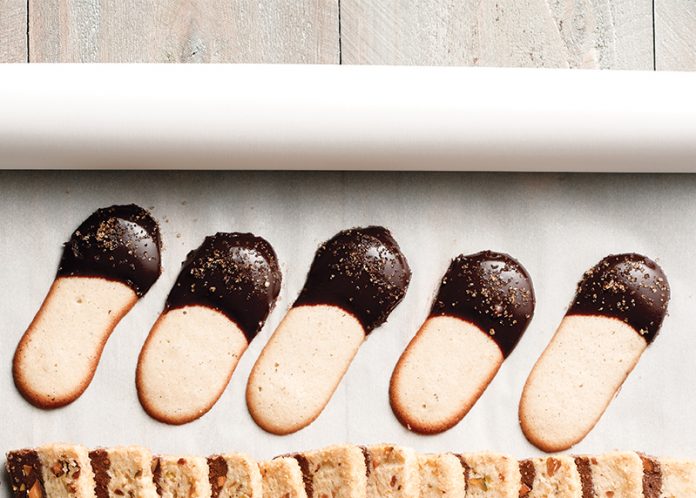 Langues de Chat dipped in chocolate on parchment