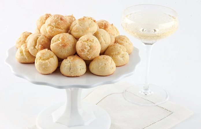 Gougères with champagne on white