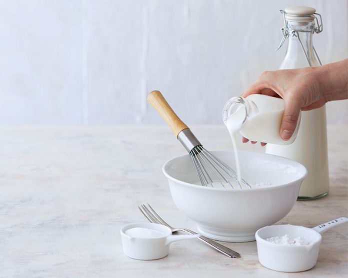 pouring buttermilk into a bowl.