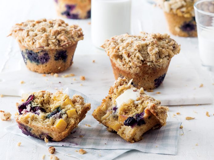 Peach and Blueberry Cornmeal Muffins split with butter