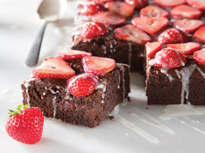 Strawberry Lillet Brownies on white sliced and topped with strawberries baking recipe