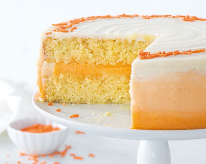 Orange Cream Cake on white cake stand