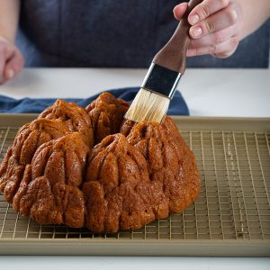 pumpkin spice bundt cake brushing with butter