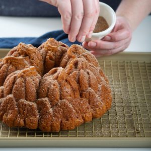 topping pumpkin spice bundt cake with topping