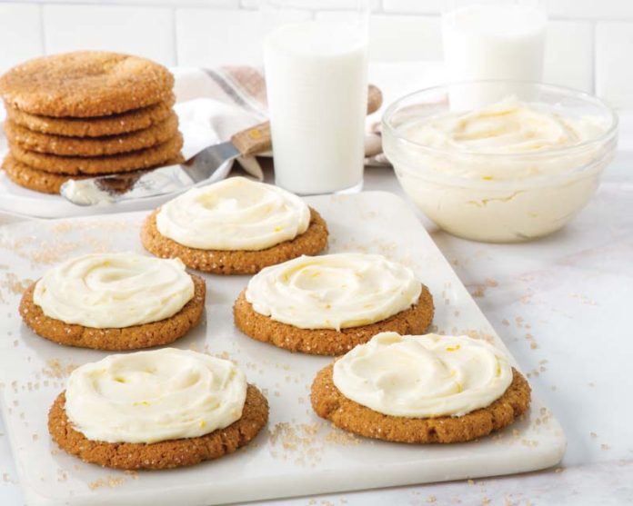Molasses Ginger Crinkle Cookies with Frosting with glasses of milk