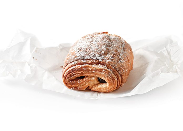 where to find the best Pain au Chocolat bakeries. Pain au chocolate on white parchment