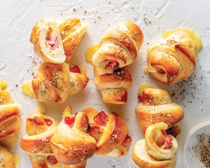 Ham and Gruyère Crescent Rolls on white surface